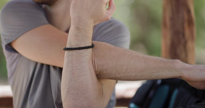 Unique arm flexibility challenge viewed in a sunny outdoor setting with friends engaged in fun activities during the afternoon