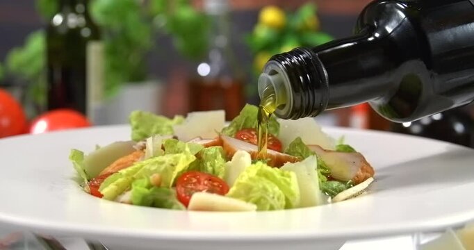 Olive oil pouring onto caesar salad slow motion 1000 fps
