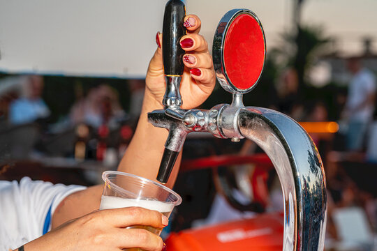 A professional beer draft machine pouring fresh lager into glass steins. Perfect for Oktoberfest festival concepts, pub bar equipment, and traditional German beer celebrations.


