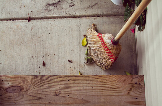 Corn Broom on Exterior Porch with Dirt and Leaves, Close View, Sweeping a Dirty Porch