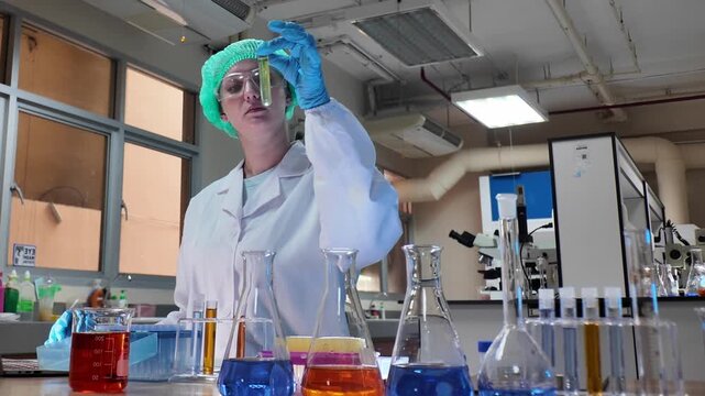 Laboratory room. Female scientists conducting laboratory research with colorful chemical samples. Using test tubes flasks and microscopes for scientific analysis and experimentation. Bio or chemical