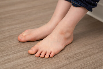 Delicate child's soles grace the floor as tiny bare feet make contact, revealing the purity and simplicity of early life © Konstiantyn Zap