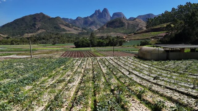Aerial view of Tres Picos de Friburgo with lush agricultural fields and greenhouses in Nova Friburgo, Rio de Janeiro, Brazil.