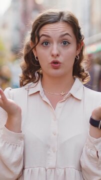 I dont know what to say. Confused young woman feeling embarrassed about ambiguous question, having doubts, no idea, being clueless uncertain. Portrait of lady walking in urban city street outdoors
