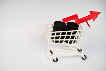 Shopping cart filled with oil barrels and rising arrow representing increasing energy prices isolated on white background  © kaliel