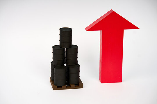 Stacked oil barrels beside large upward arrow representing rising petroleum prices isolated on white background
