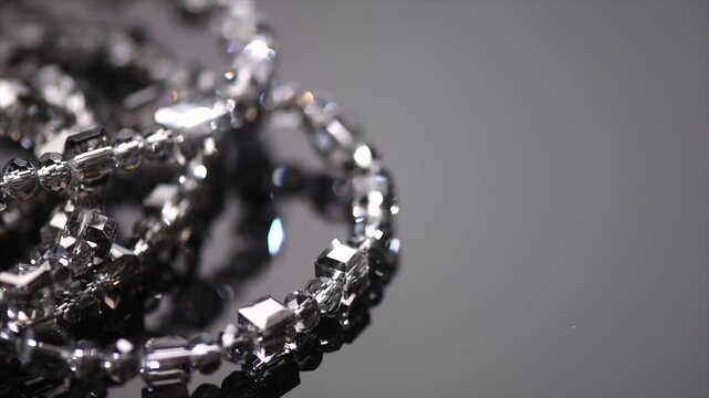 Crystals bracelet or necklace border jewels, gems, diamonds over black background, beautiful gems, rhinestones, brilliants sparkling with colorful caustics, rainbow lights. Moissanite. Zirconia 