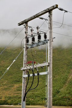 Rural Power Distribution Pole with Switches, Surge Arresters and Underground Cables, Foggy Mountains