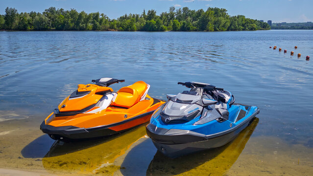 Personal Watercraft Parked on Sandy Lake Shore on Sunny Summer Day