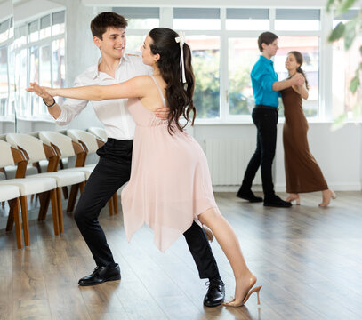 Guy is professional dancer and teacher focused on his female partner, teaching her to perform incendiary tango during off-site workshop.