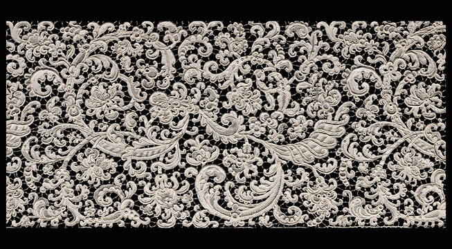 Ornate white lace texture with floral pattern on black background