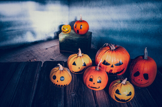 scary funny Halloween pumpkins on wooden table