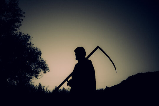 grim reaper, the death itself, scary horror shot of Grim Reaper holding scythe