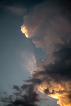 View of dramatic storm clouds illuminated by golden sunset light in the sky over Costa Rica.