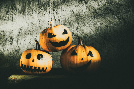 scary funny Halloween pumpkins on wooden table