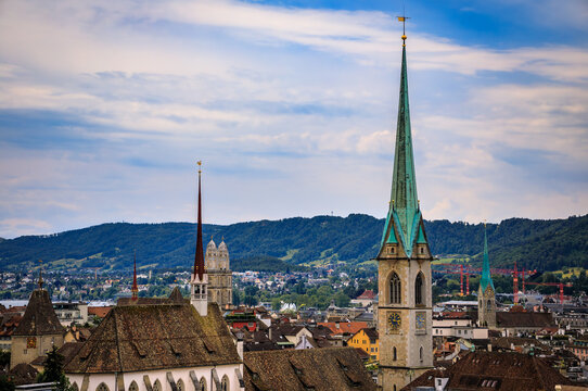 Historic church spires above tiled old town roofs, Zurich, Switzerland cityscape