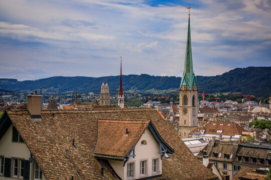 Historic church spires above tiled old town roofs, Zurich, Switzerland cityscape