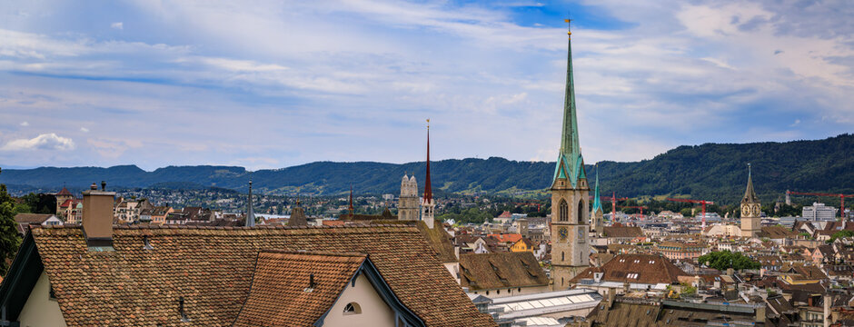 Historic church spires above tiled old town roofs, Zurich, Switzerland cityscape