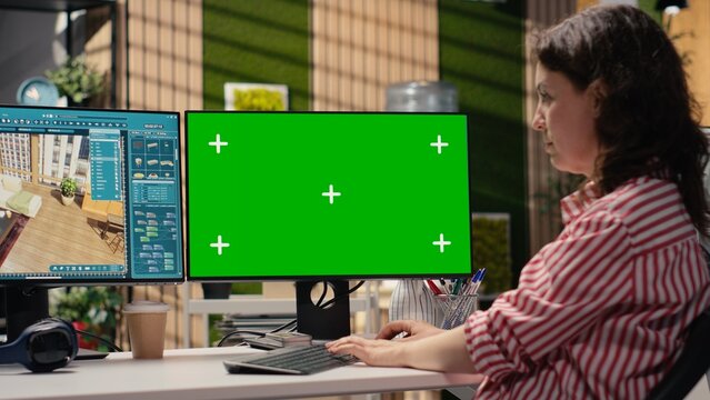 Woman uses architectural 3D software and an isolated chroma key screen to design a modern interior layout and construction blueprints for remodeling.