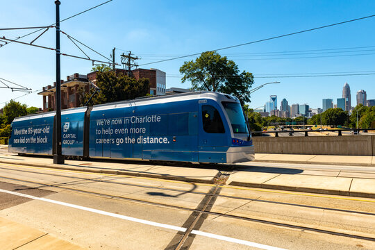 Charlotte Area Transit System, CATS, Lynx Gold Line Streetcar crosses the Central Ave bridge with a view of the Uptown Charlotte skyline