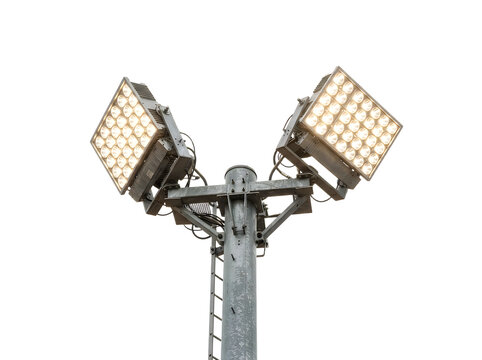 Bright stadium floodlights on a metal pole illuminate a dark space powerful lighting equipment isolated on transparent background