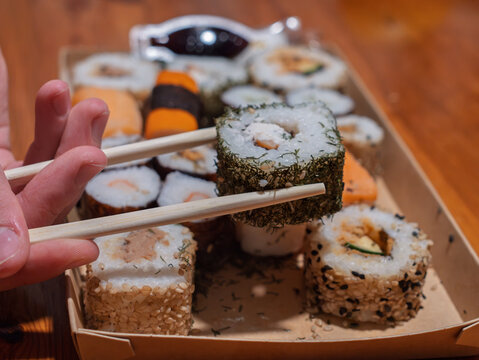 Savoring Delicious Sushi Rolls with Traditional Chopsticks