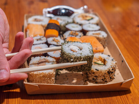 Savoring Fresh Sushi Rolls with Chopsticks
