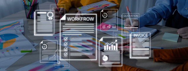 Obraz premium Business professionals collaborating on project documents featuring workflow, invoices, and quotations, with graphs and colorful charts in a modern office setting. Bitwise.