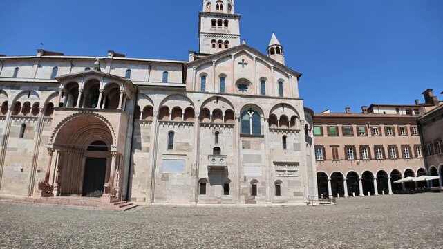 Wideangle view of the historic Modena cathedral, a unesco world heritage site, basking in sunlight in the Piazza Grande, Italy of Modena city in Italy