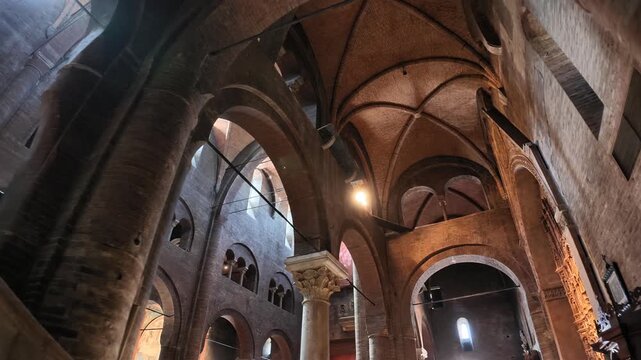 Top view of the historic Modena cathedral interior, showcasing its Grand architecture, pews, and stained glass window in the heart of Modena of Modena city in Italy