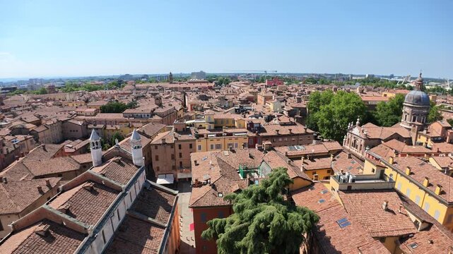 Stunning aerial panorama of Modena's historic downtown, captured from the iconic Ghirlandina bell tower overlooking the vibrant Piazza Duomo square and San Geminiano cathedral of Modena city in Italy