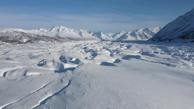 Low Aerial Shot of Snowy Mountain Range and Glacial Ice Drift