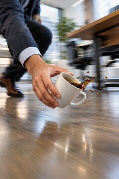 Hand Catching Spilled Coffee Cup