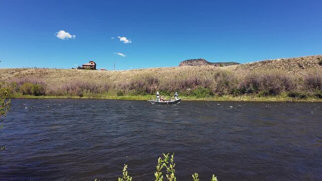 Fly Fishing Drift Boat With Anglers Casting On The Rio Grande River in Colorado During Hatch