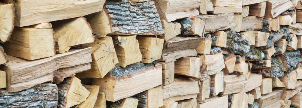 Woodpile firewood with cut logs stacked