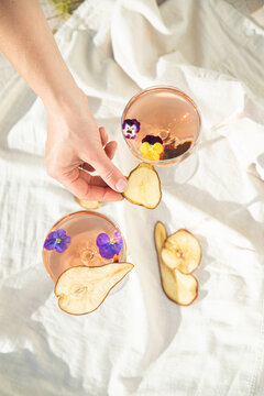 Two rose wine glasses on white fabric top view. Summer cocktails