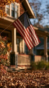 a house with an American flag prominently displayed in the foreground. The house is a twostory structure with a red brick exterior and white columns. The American flag.