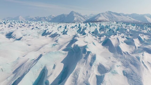 Panoramic Drone Shot Flying Across Blue Glacier Ice Formations