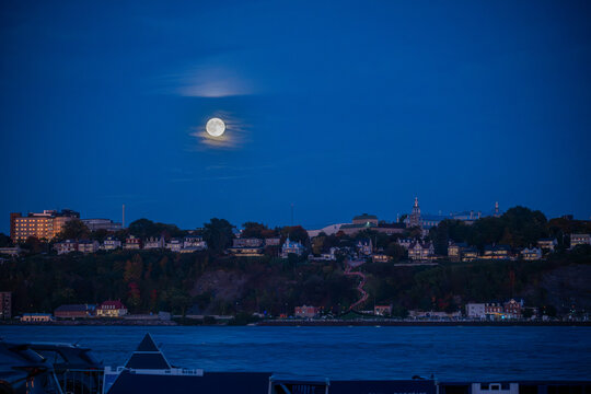 Full moon over L&eacute;vis, Quebec, Canada during blue hour