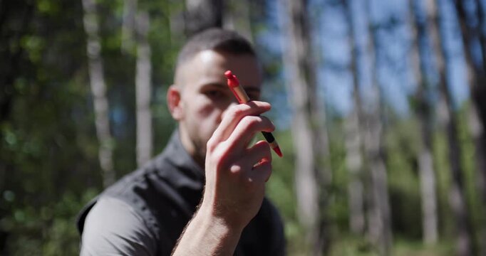 Demonstration of target practice skills in a forest setting during bright daylight with a focus on precision and technique