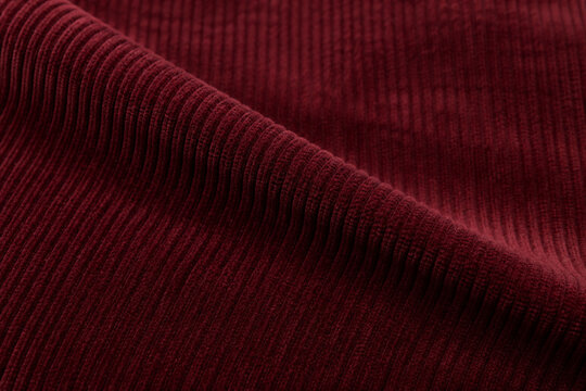 Burgundy corduroy fabric with soft folds