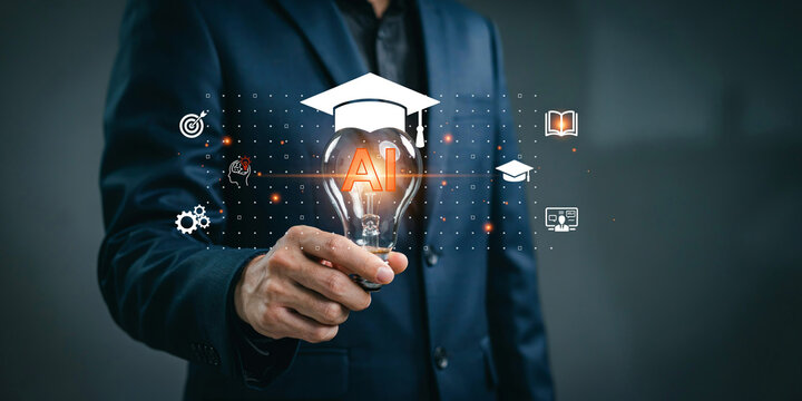 Businessman holding light bulb with graduation cap icon representing artificial intelligence in education technology.