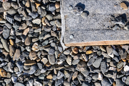 Quebec, Canada, 22 August 2026 : Geotextile fabric membrane secured next to gravel aggregate layer on outdoor construction site