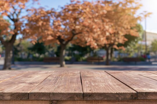 Wooden table with blurred autumn park background