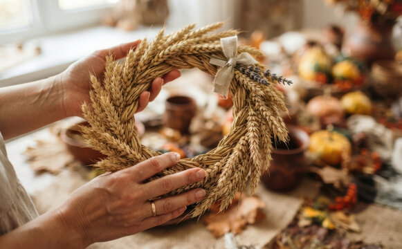 Woman holding handcrafted autumn wheat wreath with bow for seasonal harvest decor and Thanksgiving celebration