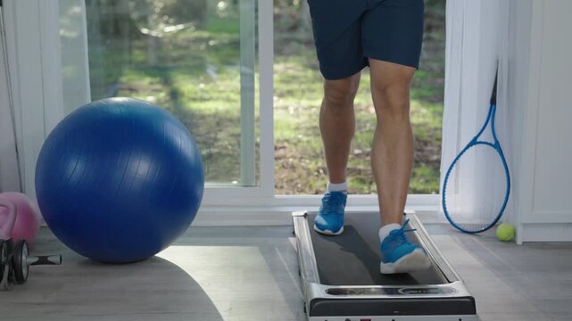 Treadmill workout in fitness gym. Exercise cardio. Sport man legs do sport. Sportsman has cardio workout to burn calories. Sneakers walking. 4k footage. Sportsman running on treadmill in gym