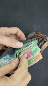 Checking Cash and Daily Budget with Indonesian Rupiah in a Wallet.