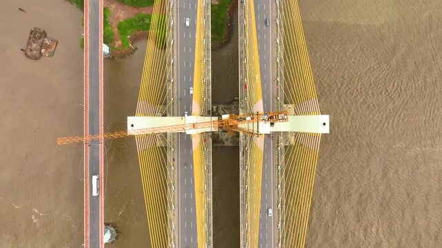 Aerial view of the New Zuari Bridge with cable-stayed design spanning the river with traffic in Quelossim, Goa, India.