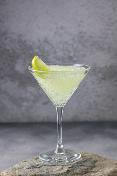 Frozen margarita with lime wheel in glass