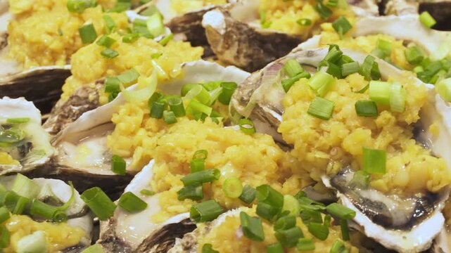 Fresh oysters are ready for grilling at a food market
